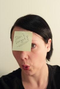 What Is Forgetfulness? Woman with post it note on forehead