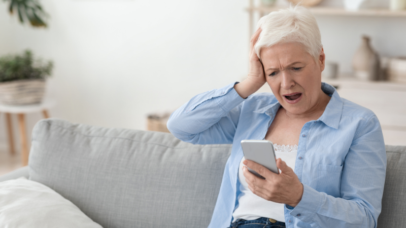 Should a Person with Dementia Have a Phone? Elderly woman confused using cell phone