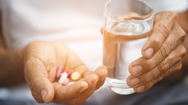 Failure To Thrive in the Elderly As A Cause of Death - Hand holding pills