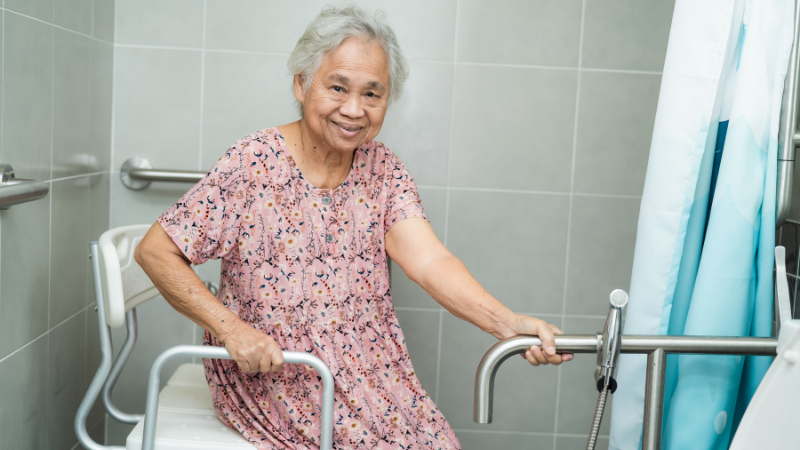 How Often Should Elderly Shower Optimal Frequency -Elder woman setting on shower chair