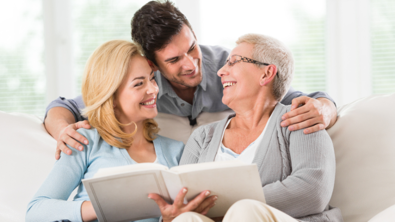13 Benefits of Reminiscing for Seniors - Older woman with younger couple all smiling
